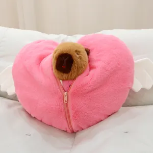 Adorably cute capybara plush toy featuring a pink heart pillow and angel wings, soft doll gift.