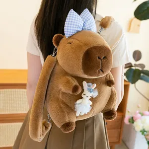Zaino in peluche capibara carino con fiocco blu e ciondolo coniglio, borsa morbida per ragazze.