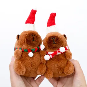 Cute Christmas capybara plush keychain, detailed view of holiday hat and soft fabric.