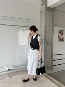 Detailed view of women's split-toe flat shoes styled with a chic minimalist outfit in a modern showroom.