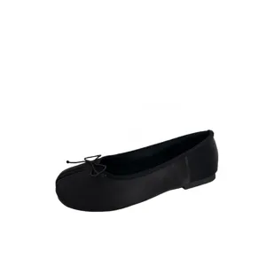 Black split-toe flat shoes with delicate bow detail, comfortable minimalist design footwear.