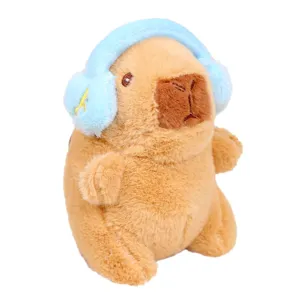 Cute capybara plush toy pendant with blue earmuffs, soft stuffed animal keychain charm.