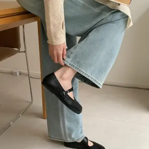Black flat Mary Jane shoes detail view, soft sole casual footwear for women daily wear.