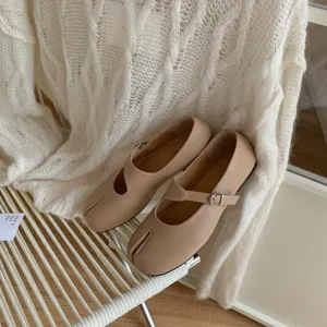 Beige split toe mary jane flat shoes detail, minimalist chic design for women spring wear.