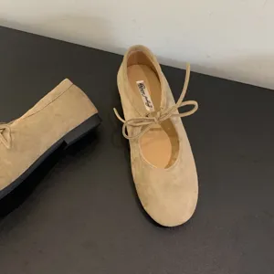 Women's genuine leather flat ballet shoes with chic lace-up bow mary jane design.