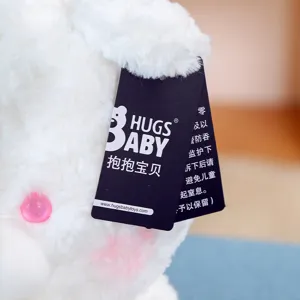 Cute fluffy white plush teddy bear toy detail, soft stuffed animal toy with tag.