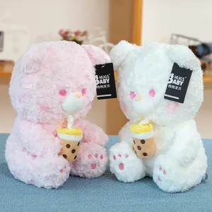Cute plush teddy bear holding boba milk tea doll, soft rose velvet stuffed toy gift for kids.