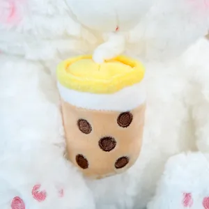 Plush bear toy detail featuring a cute boba milk tea cup design with soft fluffy white fur.