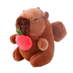 Cute Capybara plush toy keychain with red apple pendant, soft brown animal doll main view.