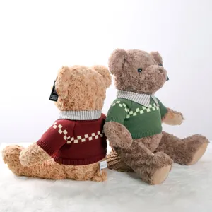 Plush teddy bear toy with vintage sweater and striped collar, soft hugging doll for kids.
