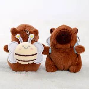Dettaglio portachiavi peluche capibara carino, morbido animale marrone con ape dolce.