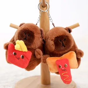 Cute capybara plush keychain with mini food snack toy hanging on display stand detail.