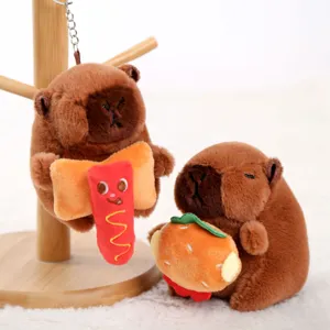 Cute capybara plush keychain with soft brown stuffed animal holding burger and hotdog.