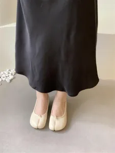 Comfortable beige split toe flat shoes detail view, soft leather daily casual footwear.