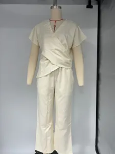 Detail view of a solid color short sleeve crossover top and matching pants outfit set.