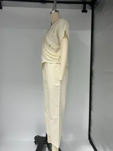 Detail view of a solid beige women's summer short-sleeve wrap top and pants set.