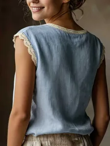 Details of a casual sleeveless linen blouse with delicate lace trim on the round neckline.