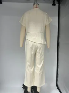 Back detail of the solid color irregular short sleeve top and trousers two piece set.