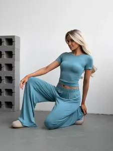Stylish women's two-piece knitted lounge set featuring a short sleeve top and wide leg pants.