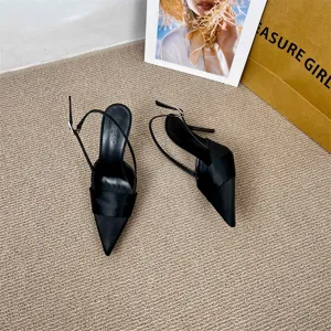 Black satin pointed toe stiletto high heel slingback sandals detail view showing elegant texture.