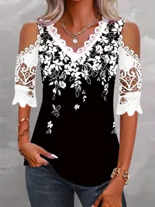 Close-up view of the elegant cold shoulder lace trim and floral print details on the blouse.