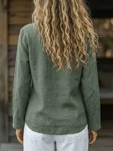 Detailed back view of casual loose long sleeve green linen blouse showing texture details.