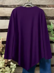 Detail view of the solid color long sleeve top, featuring an irregular hem and O-neck.