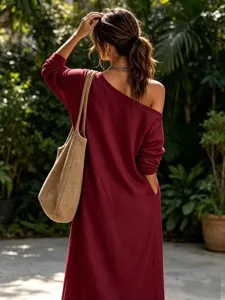 Detail view of loose linen blend one-shoulder long sleeve dress in elegant burgundy color.