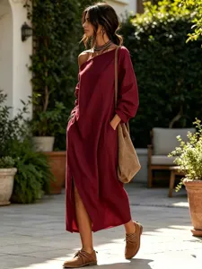 Detailed view of the loose one-shoulder linen maxi dress with side slit in elegant burgundy.