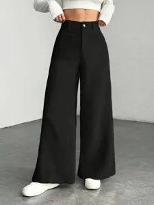 Detail shot of black high waisted wide leg pants featuring ribbed texture and stylish fit.