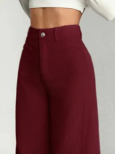 High-waisted corduroy wide-leg pants detail, burgundy winter casual trousers close-up fit.