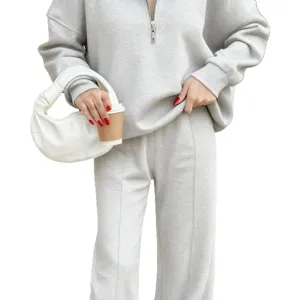 Casual women half-zip sweatshirt and matching trousers two-piece loungewear set in light grey.