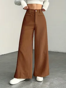 Close-up detail of brown corduroy wide-leg pants featuring high waist and casual style.