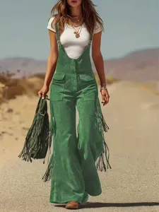 Detailed view of the green suede fringe overalls showcasing the side tassels and pocket design.