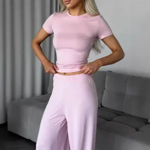 Women pink knit short sleeve t-shirt and long pants set casual two piece lounge wear.
