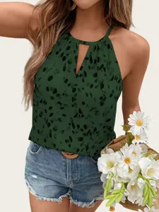 Detailed view of green halter top with abstract print, sleeveless and chic keyhole front.