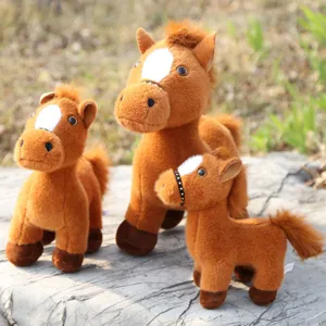 Detailed shot of cute brown plush toy horse with white blaze and reins, soft texture.