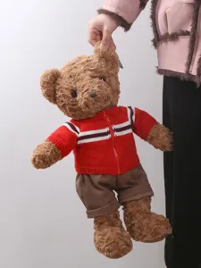 Plush teddy bear toy wearing a red knitted cardigan and brown shorts, soft doll gift.