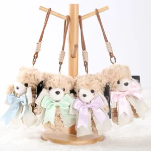 Cute plush teddy bear keychain detail, fluffy bear bag charm with soft bowknot.
