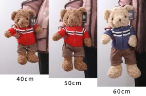 Detailed view of the Hugs Baby plush teddy bear wearing a knitted sweater, cute doll gift.
