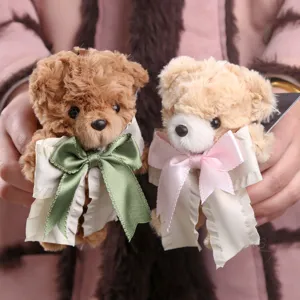 Cute plush teddy bear keychain with bowknot ribbon, soft stuffed animal bag pendant charm.
