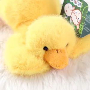 Detailed close-up of cute yellow duck plush toy, soft fluffy stuffed animal fabric.