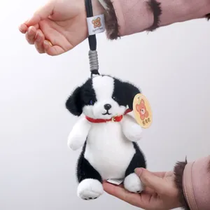 Cute black and white puppy plush toy bag pendant with red collar and lanyard for kids.