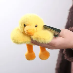 Cute yellow duck plush toy, soft and fluffy lying design with dangling feet for kids.