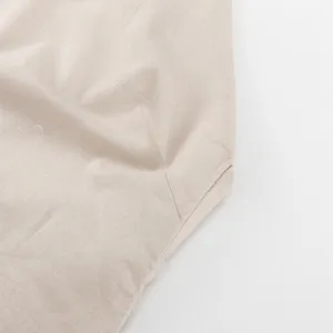 Close-up detail of casual cotton linen dress fabric in soft beige color summer style.