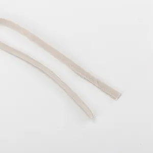 Detail shot of the beige cotton linen dress halter straps, showing fine stitching texture.