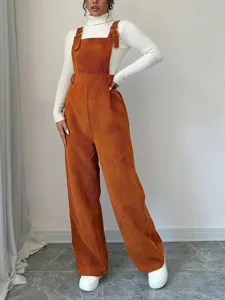 Detailed view of women casual corduroy overalls loose straight long pants in stylish orange brown color.