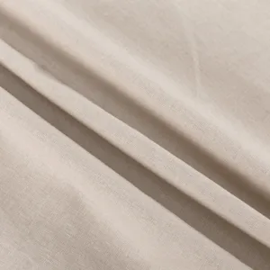 Detailed view of breathable beige cotton linen fabric with natural texture and soft drape style.