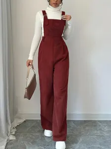 Detail view of women's corduroy wide leg overalls paired with a chic white turtleneck.