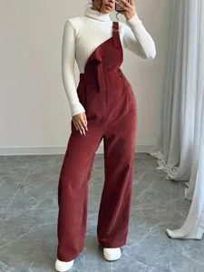 Women corduroy overalls paired with white ribbed turtleneck sweater, wide leg long pants.